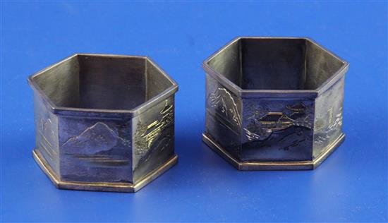 A cased pair of Japanese silver hexagonal napkin rings, 1.75in.